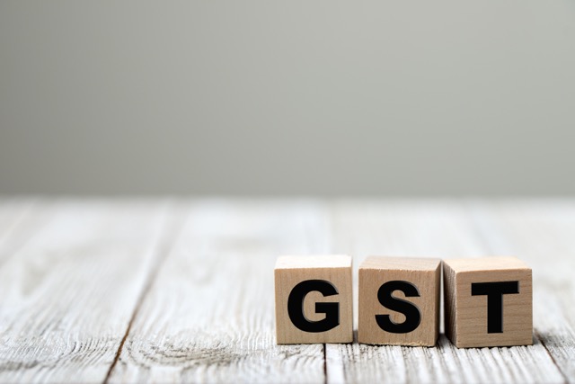 GST letters on a wooden cubes